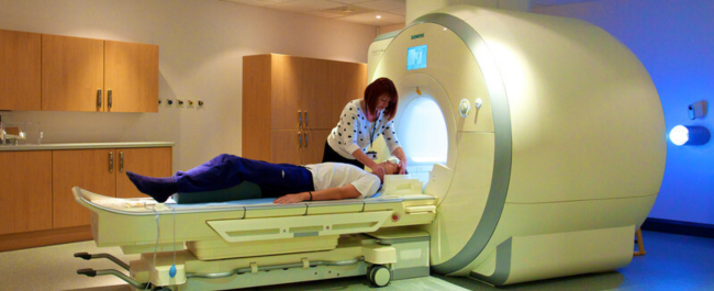 A radiographer and a patient with a similar MRI device. Image from University of Bristol Asset Bank. 
